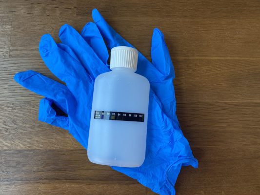 synthetic urine bottle and gloves